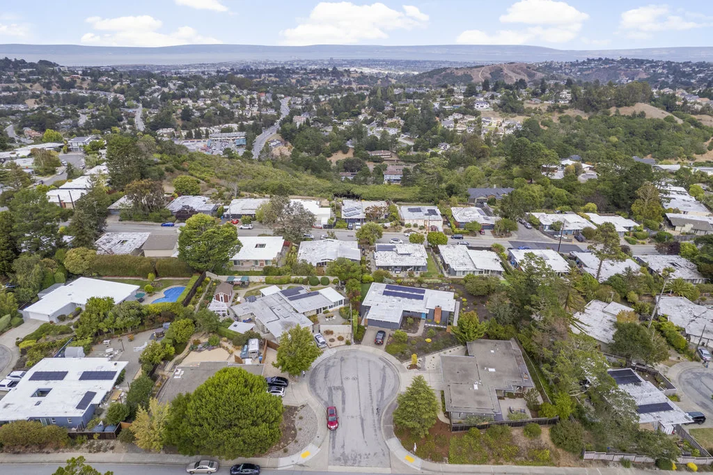 Aerial view of the San Mateo Highlands Eichler tract along the ridge, with San Francisco Bay in the distance.